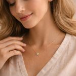 woman wearing delicate gold birthstone necklace that feels personal and meaningful